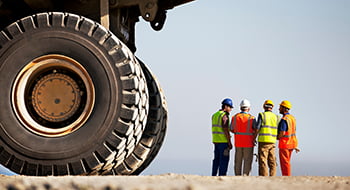 construction workers discussing project plans at a busy worksite